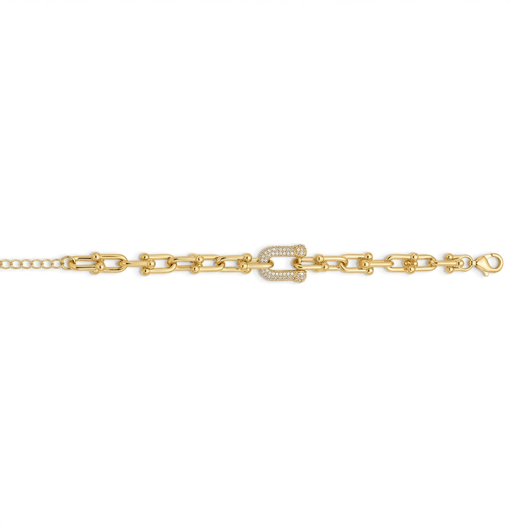 A gold chain bracelet featuring a central horseshoe-shaped link embellished with small clear stones, shown against a plain white background.