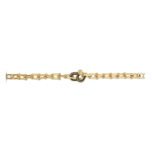 A gold chain bracelet featuring a central interlocking snakeskin motif paved with small black stones, shown against a plain white background.